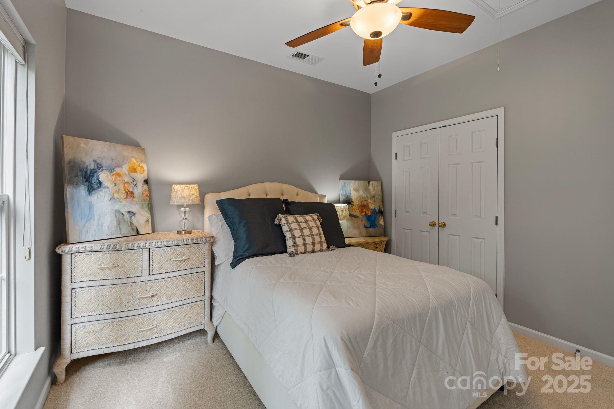 1039 Sharon Lee Avenue Fort Mill, SC 29708 - Photo 29 of 46 a bedroom with a bed and a chandelier