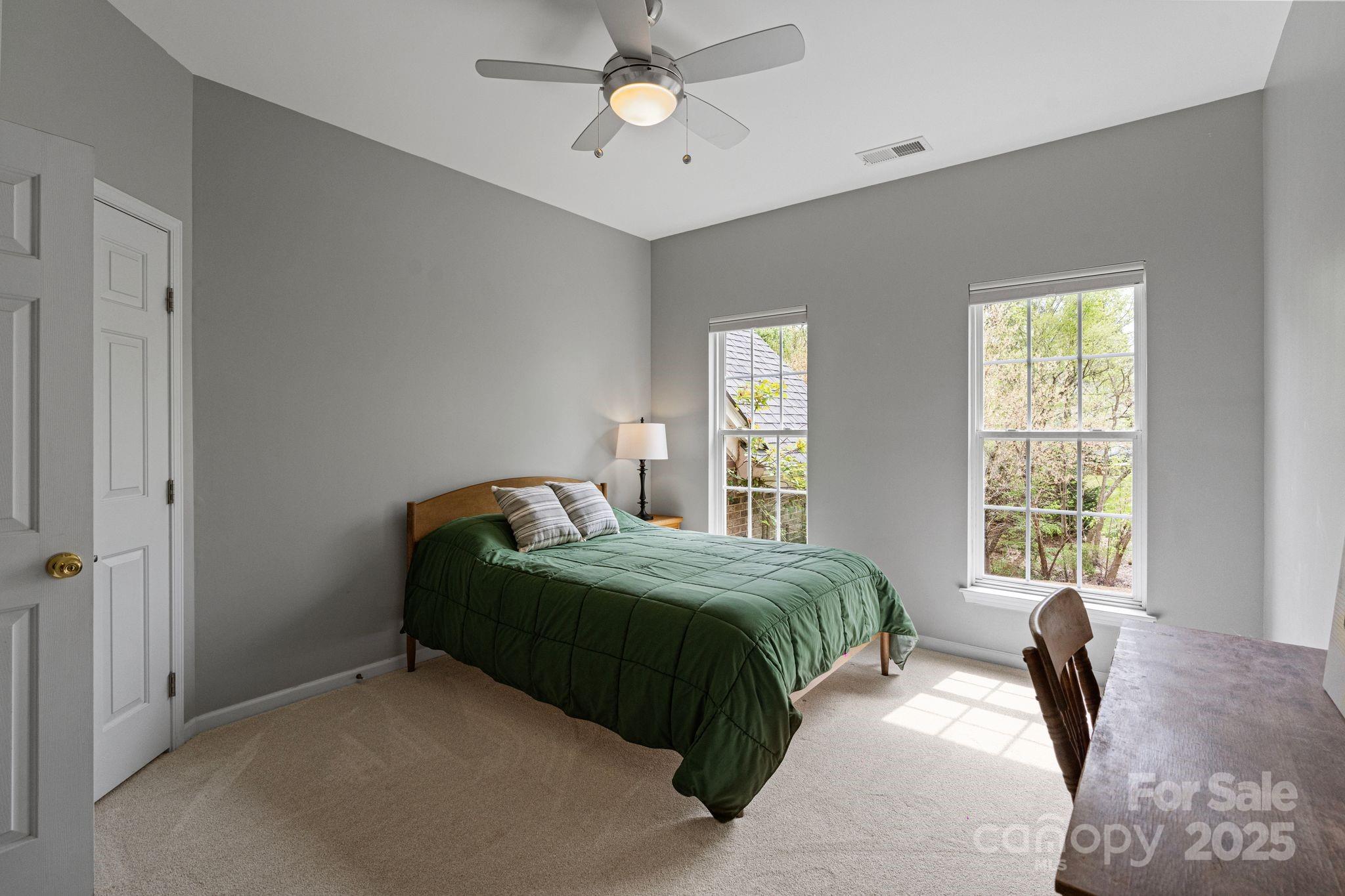 1039 Sharon Lee Avenue Fort Mill, SC 29708 - Photo 32 of 46 a bedroom with a bed and a chandelier