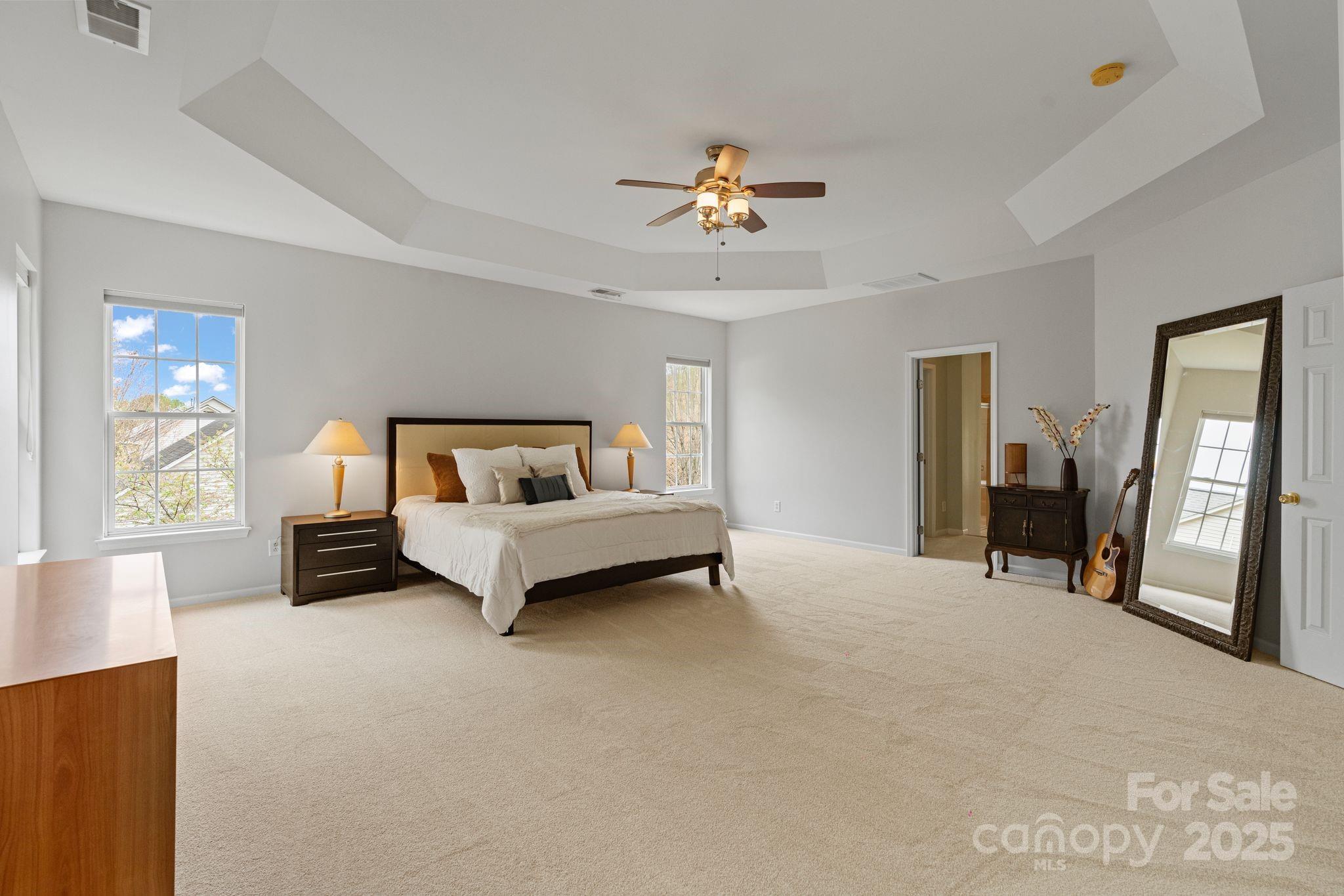 1039 Sharon Lee Avenue Fort Mill, SC 29708 - Photo 34 of 46 a bedroom with a bed and a chandelier