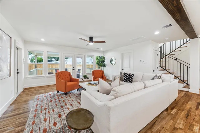 a living room with furniture a couch and wooden floor