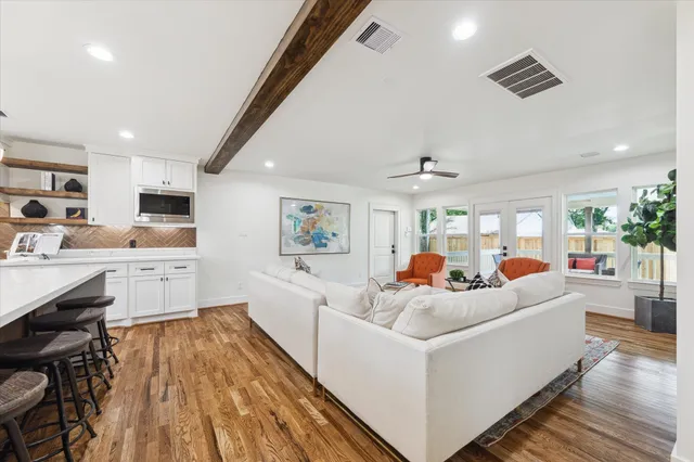a living room with furniture and a wooden floor