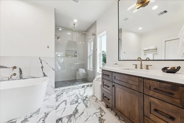 a spacious bathroom with a sink double vanity and a shower