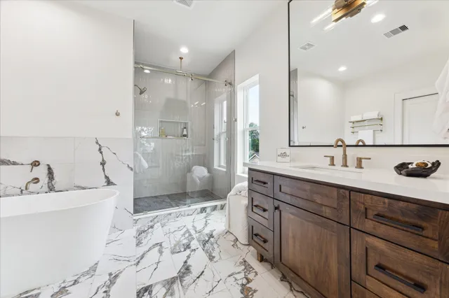 a spacious bathroom with a sink double vanity and a shower