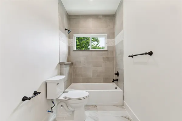 a bathroom with a toilet and a bathtub