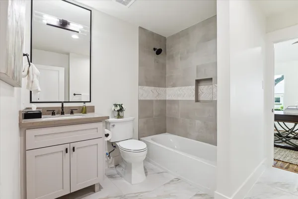 a bathroom with a sink a toilet and a bathtub