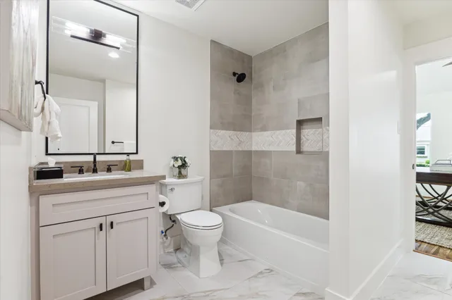 a bathroom with a sink a toilet and a bathtub