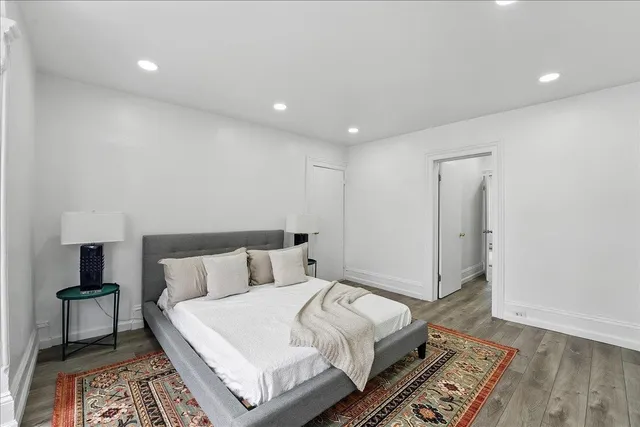 a bedroom with a large bed and a large window