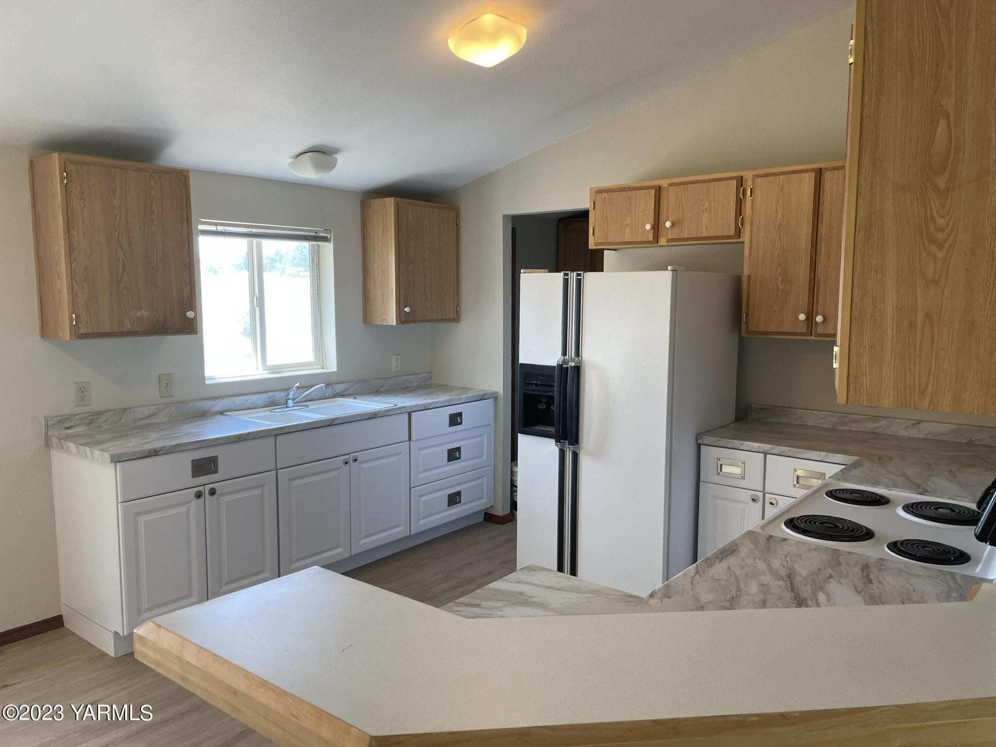 1200 South Euclid Road, Unit 89 Grandview, WA 98930 - Photo 2 of 23 a kitchen with stainless steel appliances a refrigerator sink and cabinets