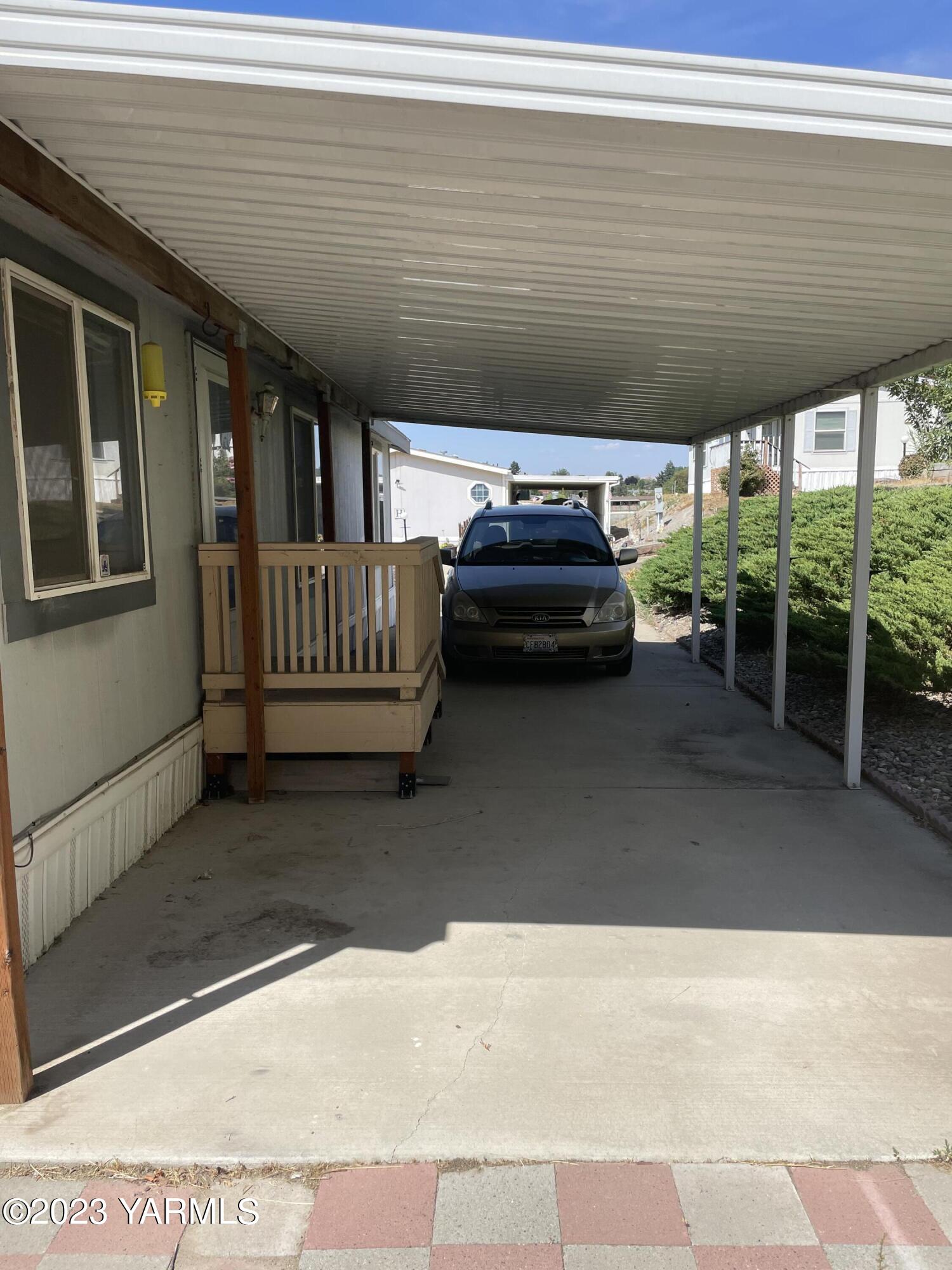 1200 South Euclid Road, Unit 89 Grandview, WA 98930 - Photo 23 of 23 a view of a porch with furniture and a yard