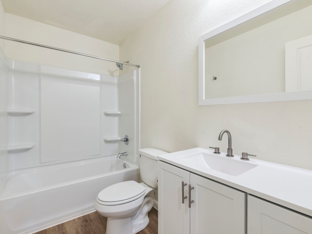 2002 West 2nd Street, Unit 902 Taylor, TX 76574 - Photo 15 of 18 a bathroom with a sink toilet and shower
