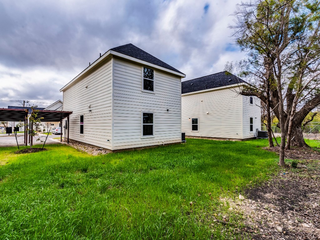 2002 West 2nd Street, Unit 902 Taylor, TX 76574 - Photo 17 of 18 a view of a white house with a yard