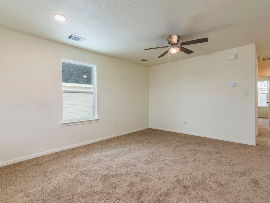 2002 West 2nd Street, Unit 902 Taylor, TX 76574 - Photo 6 of 18 an empty room with a window and a fan