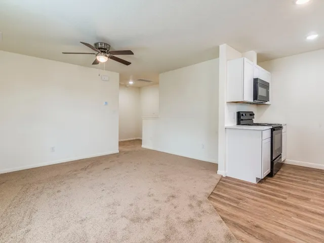 a view of a kitchen with a sink and a refrigerator