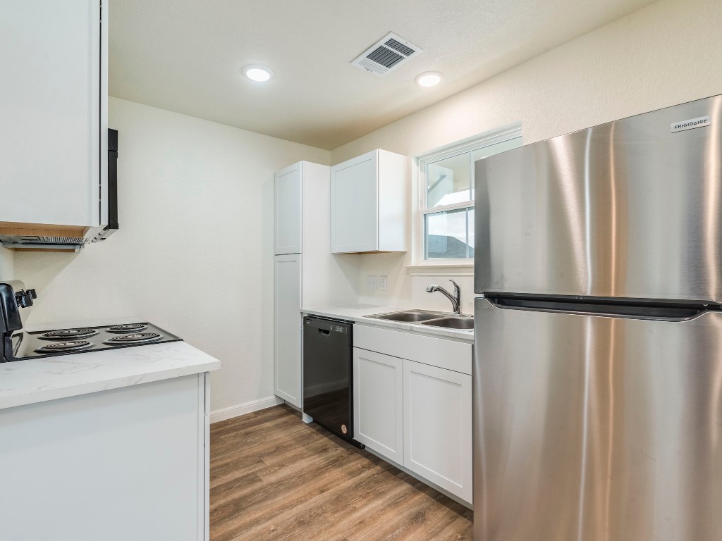 2002 West 2nd Street, Unit 902 Taylor, TX 76574 - Photo 8 of 18 a kitchen with stainless steel appliances a refrigerator sink and microwave