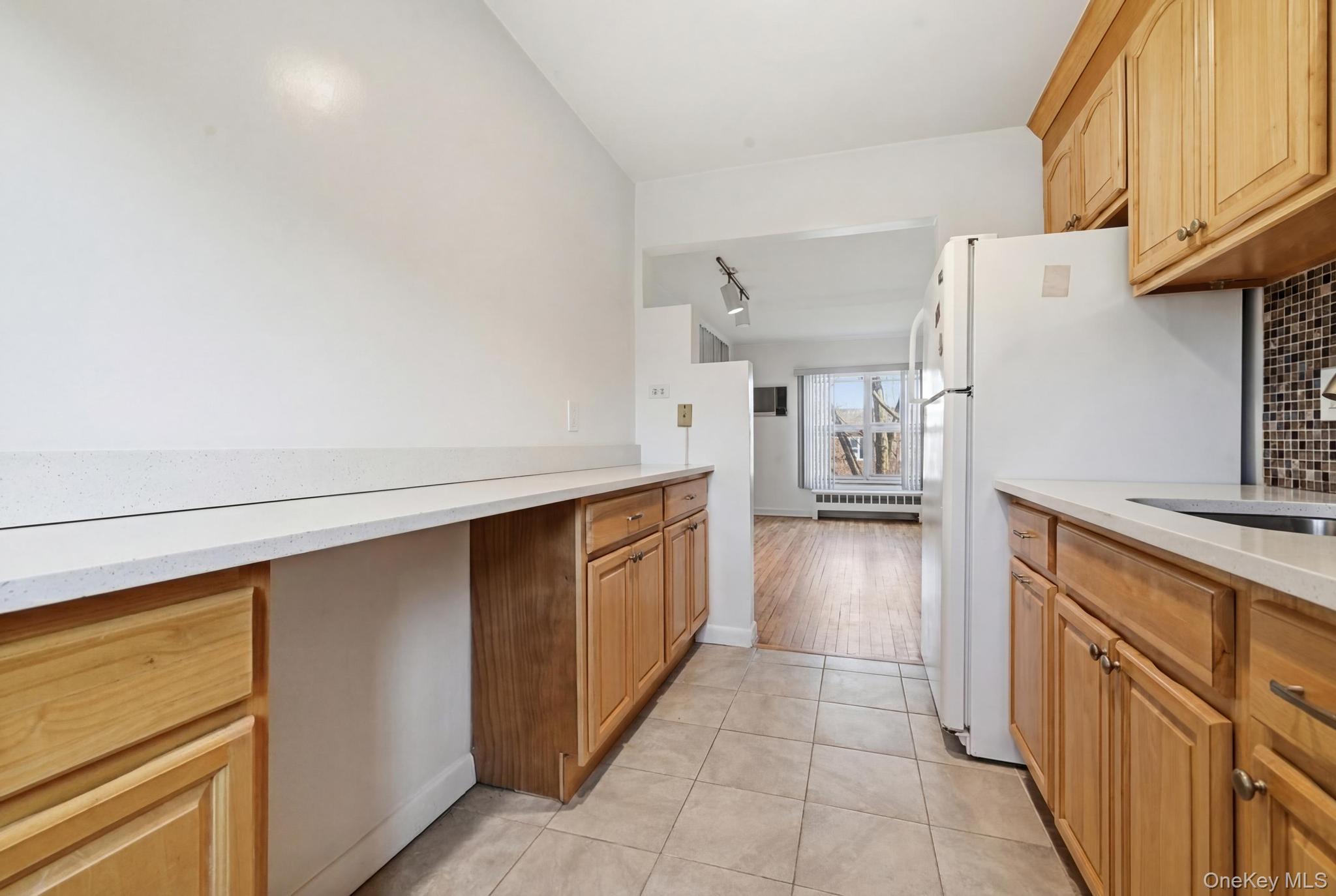 221 South Middle Neck Road, Unit F6 Great Neck, NY 11021 - Photo 12 of 16 a kitchen with a refrigerator and a sink