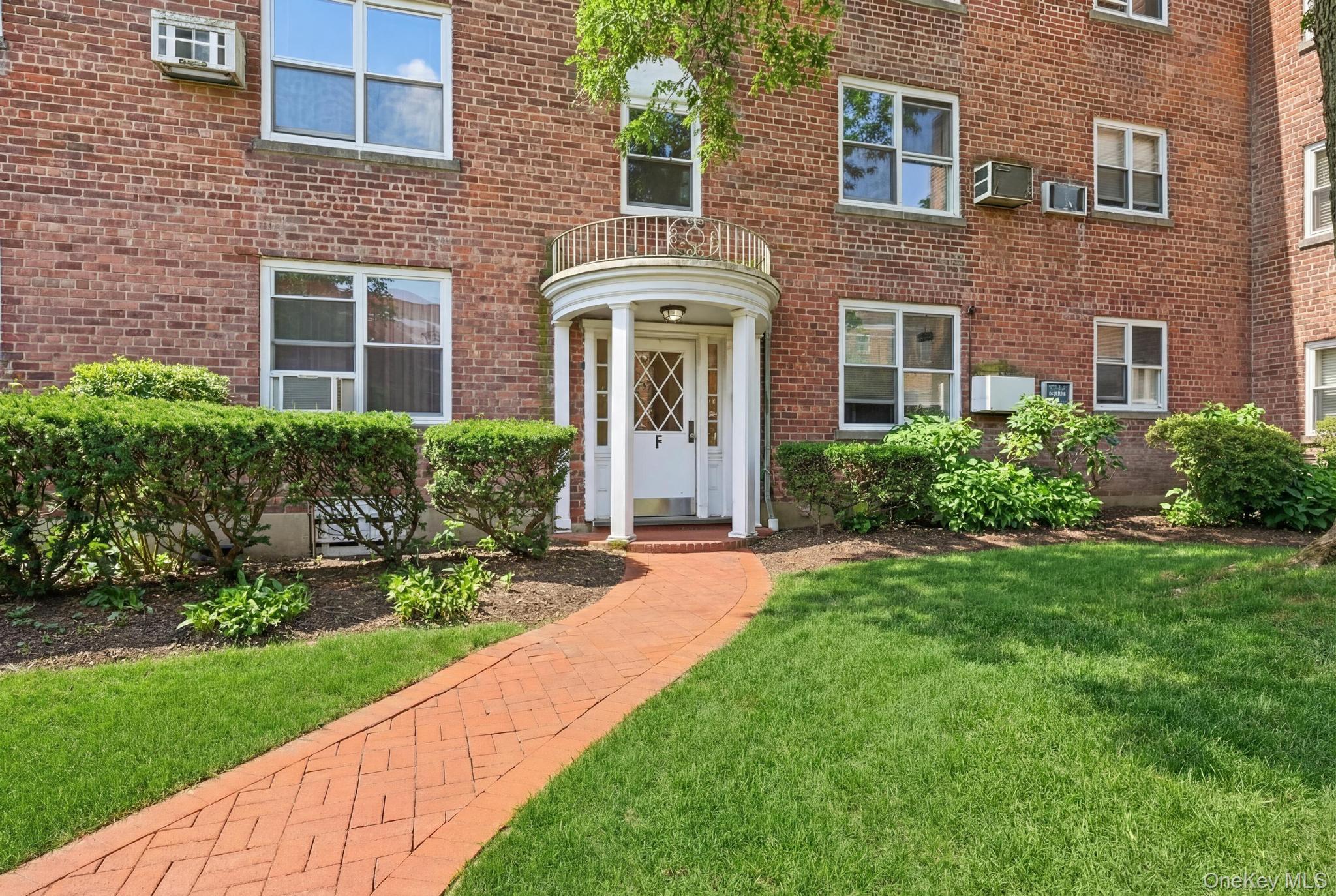 221 South Middle Neck Road, Unit F6 Great Neck, NY 11021 - Photo 2 of 16 a front view of a house with garden