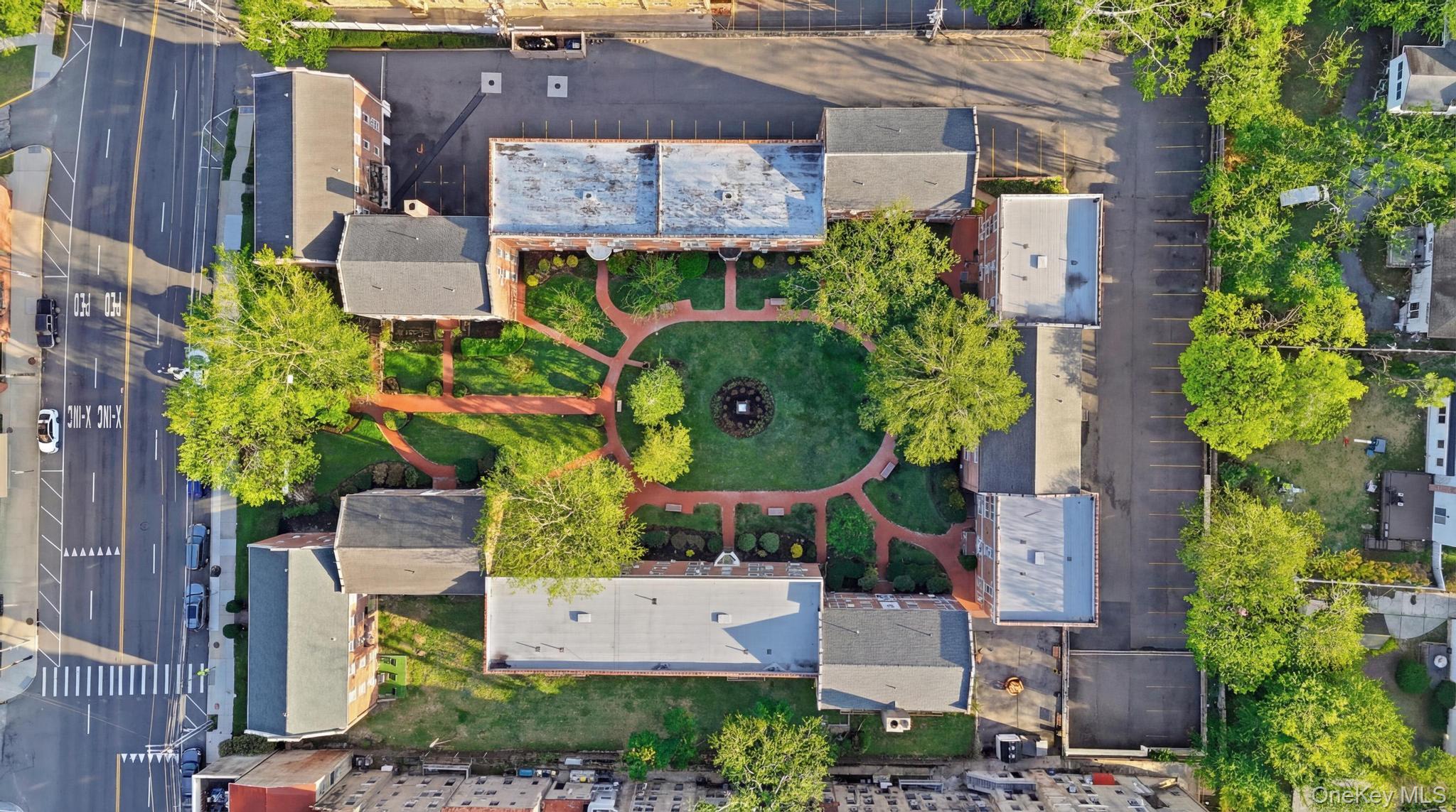 221 South Middle Neck Road, Unit F6 Great Neck, NY 11021 - Photo 4 of 16 an aerial view of a house with a garden and plants