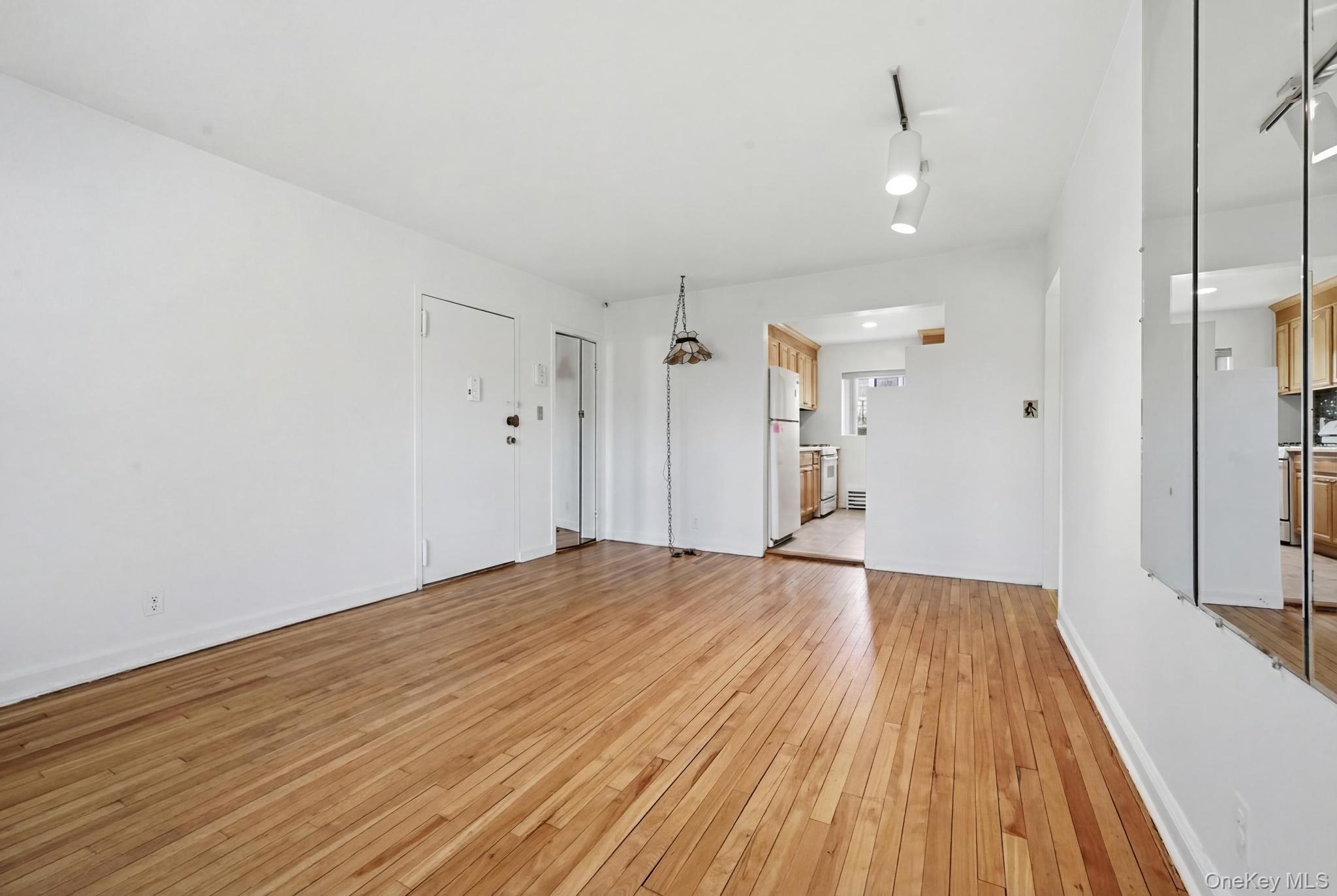 221 South Middle Neck Road, Unit F6 Great Neck, NY 11021 - Photo 10 of 16 a view of empty room with wooden floor