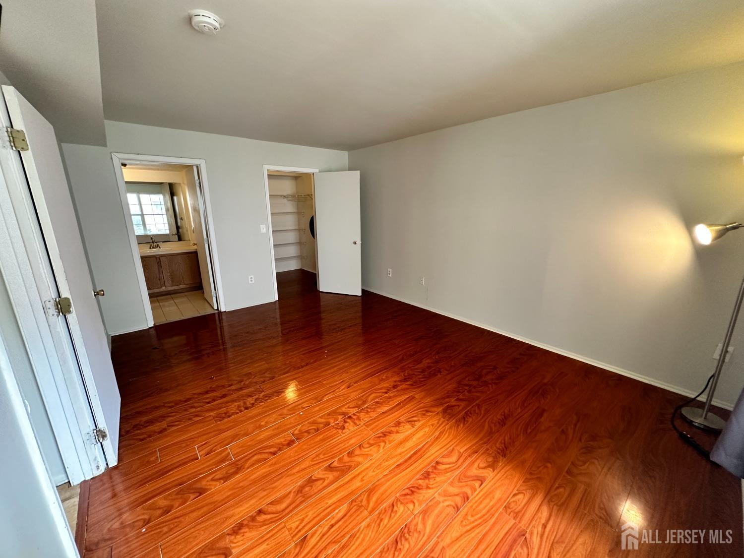 407 Plymouth Road North Brunswick, NJ 08902 - Photo 11 of 16 wooden floor in an empty room with a window