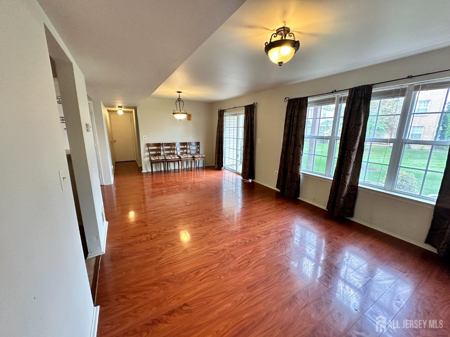 407 Plymouth Road North Brunswick, NJ 08902 - Photo 4 of 16 wooden floor in an empty room with a window