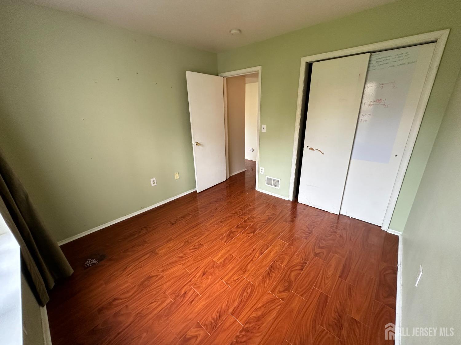 407 Plymouth Road North Brunswick, NJ 08902 - Photo 8 of 16 an empty room with wooden floor and entrance