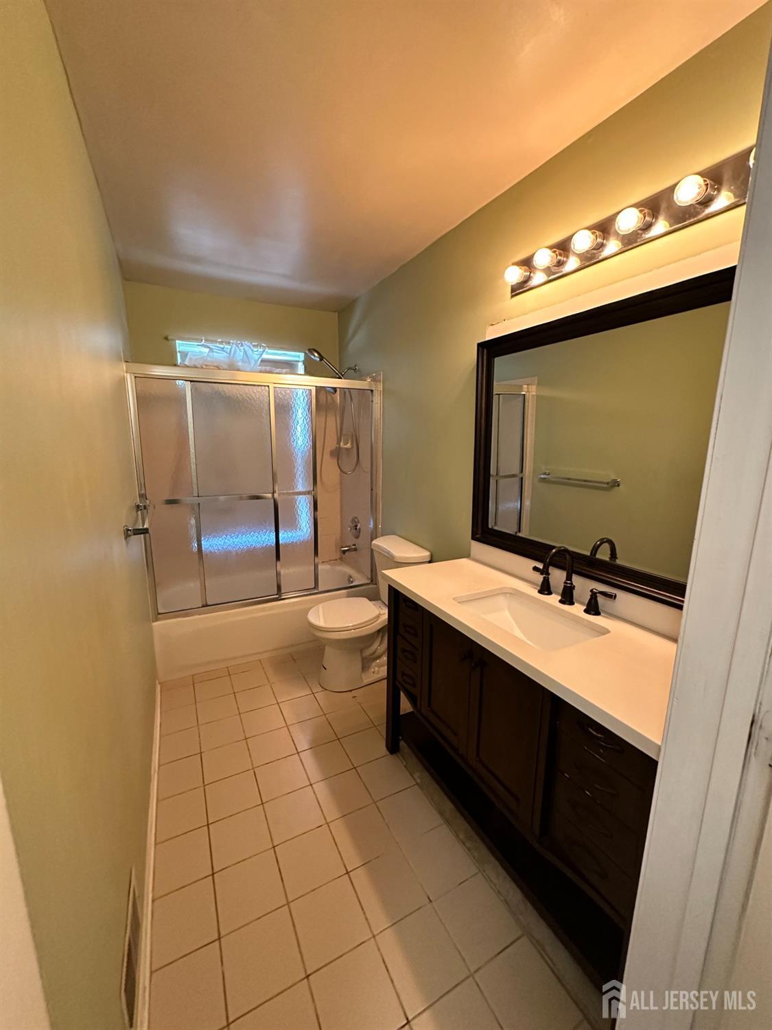 407 Plymouth Road North Brunswick, NJ 08902 - Photo 9 of 16 a bathroom with a sink vanity and mirror