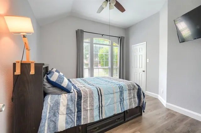 a bed sitting in a bedroom next to a window