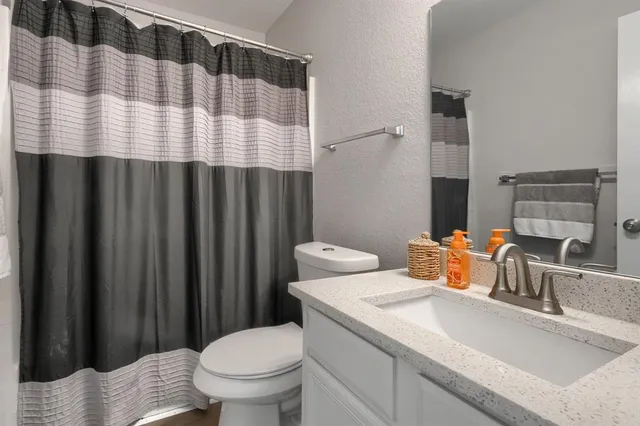 a bathroom with a sink toilet and shower