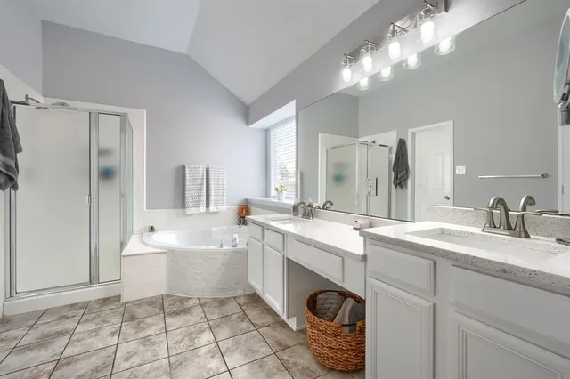 a spacious bathroom with a sink a vanity and mirror