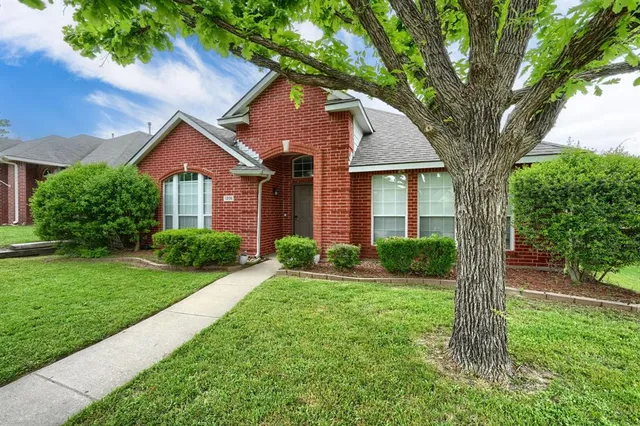 front view of a house with a yard