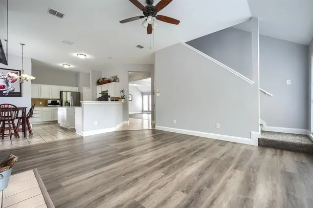 a view of a kitchen with furniture and wooden floor