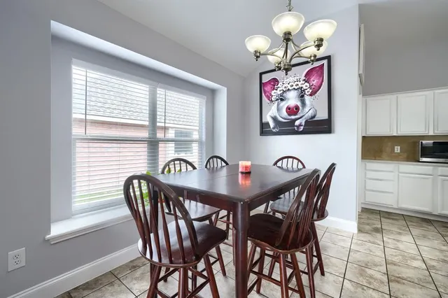 a view of a dining room with furniture and chandelier