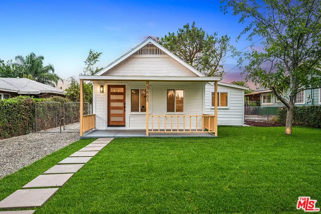a view of a house with a yard and porch
