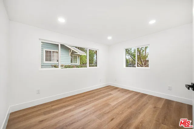 a view of a livingroom with wooden floor and window