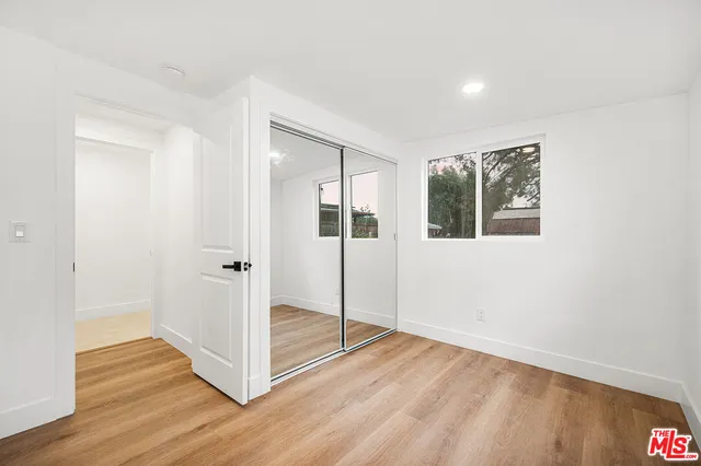 a view of a livingroom with wooden floor and window