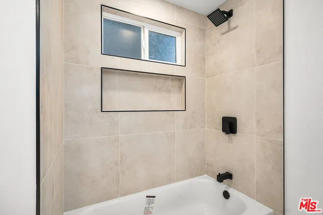 a bathroom with a bathtub and a shower