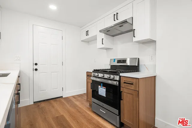 a kitchen with stainless steel appliances a stove and a refrigerator