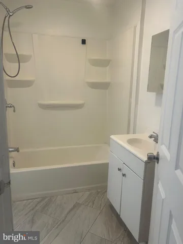 a bathroom with a sink a bath tub and a shower