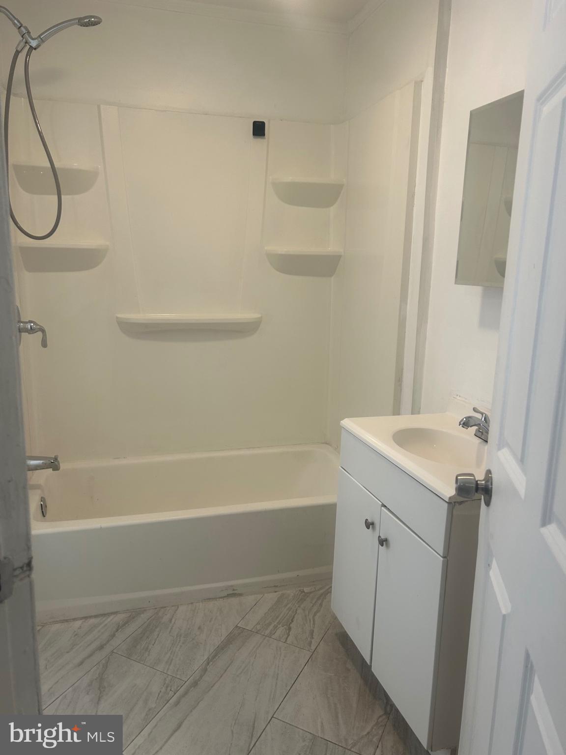 2136 North Fulton Avenue, Unit 3 Baltimore, MD 21217 - Photo 8 of 8 a bathroom with a sink a bath tub and a shower