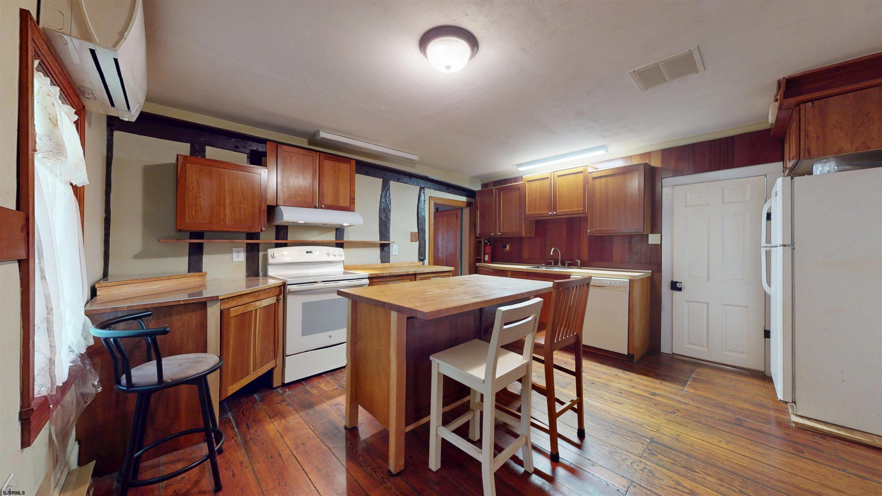 216 Old New York Road Port Republic, NJ 08241 - Photo 13 of 70 a kitchen with stainless steel appliances granite countertop a table chairs and a refrigerator