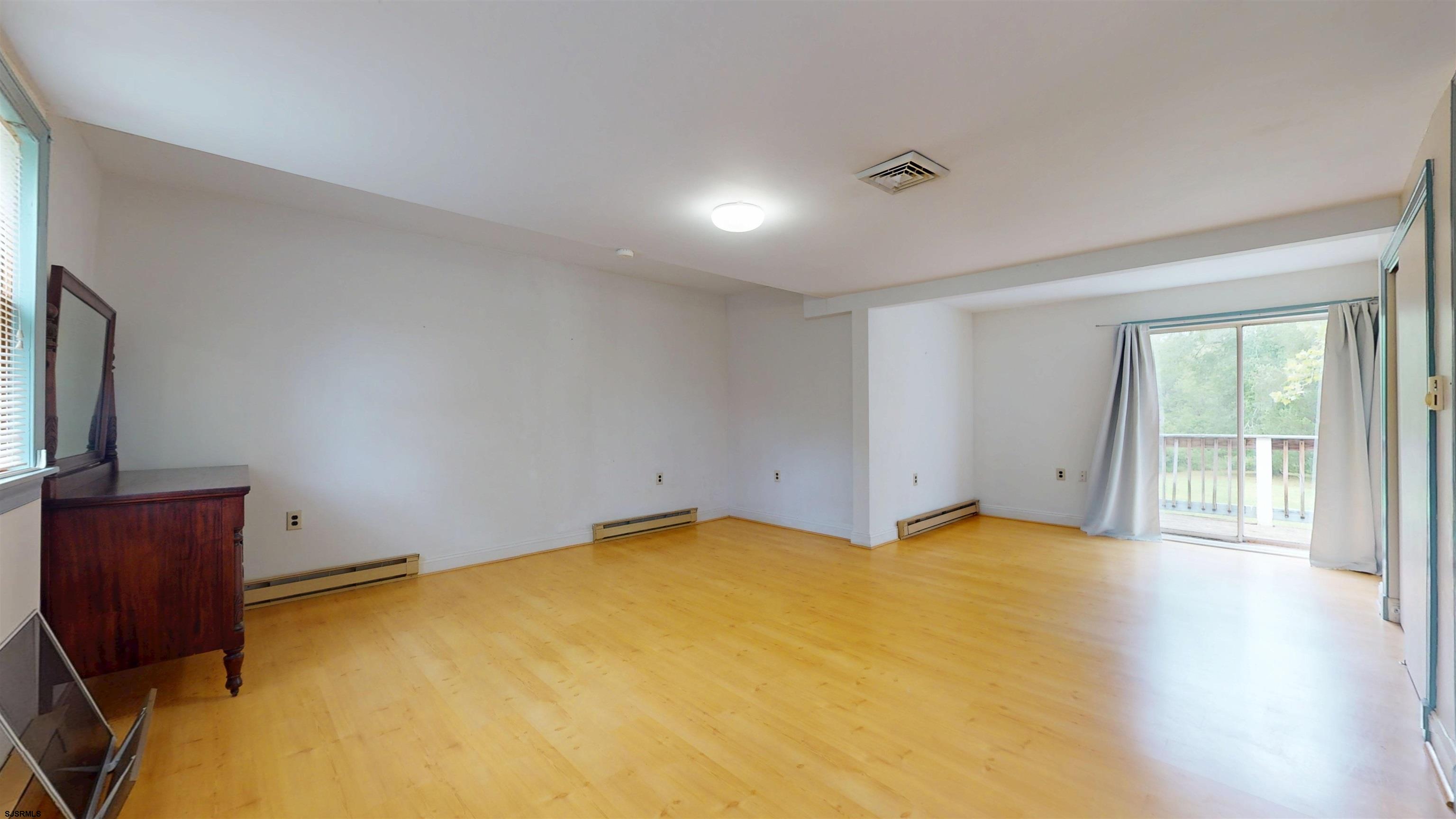 216 Old New York Road Port Republic, NJ 08241 - Photo 25 of 70 a view of an empty room with wooden floor and a window