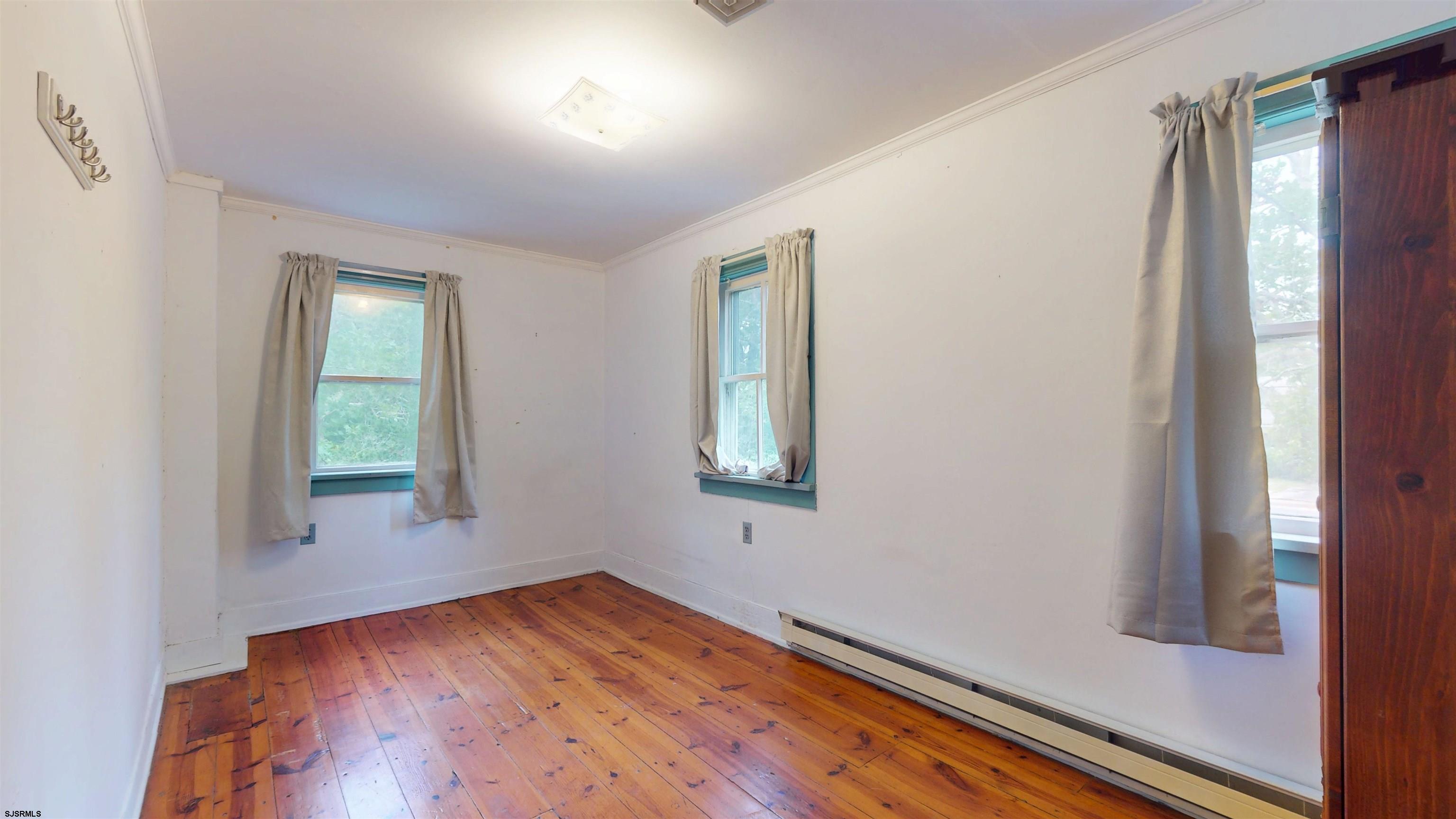 216 Old New York Road Port Republic, NJ 08241 - Photo 30 of 70 an empty room with wooden floor and windows