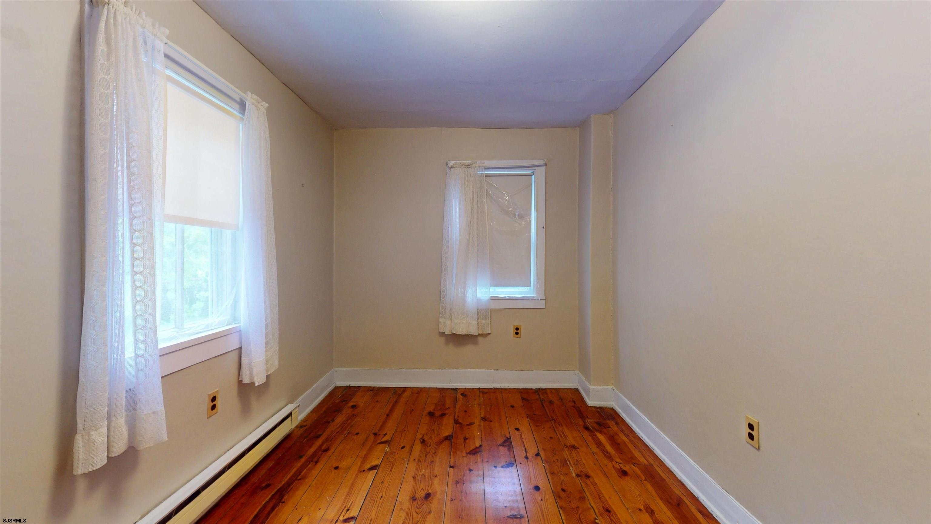 216 Old New York Road Port Republic, NJ 08241 - Photo 33 of 70 an empty room with wooden floor and windows