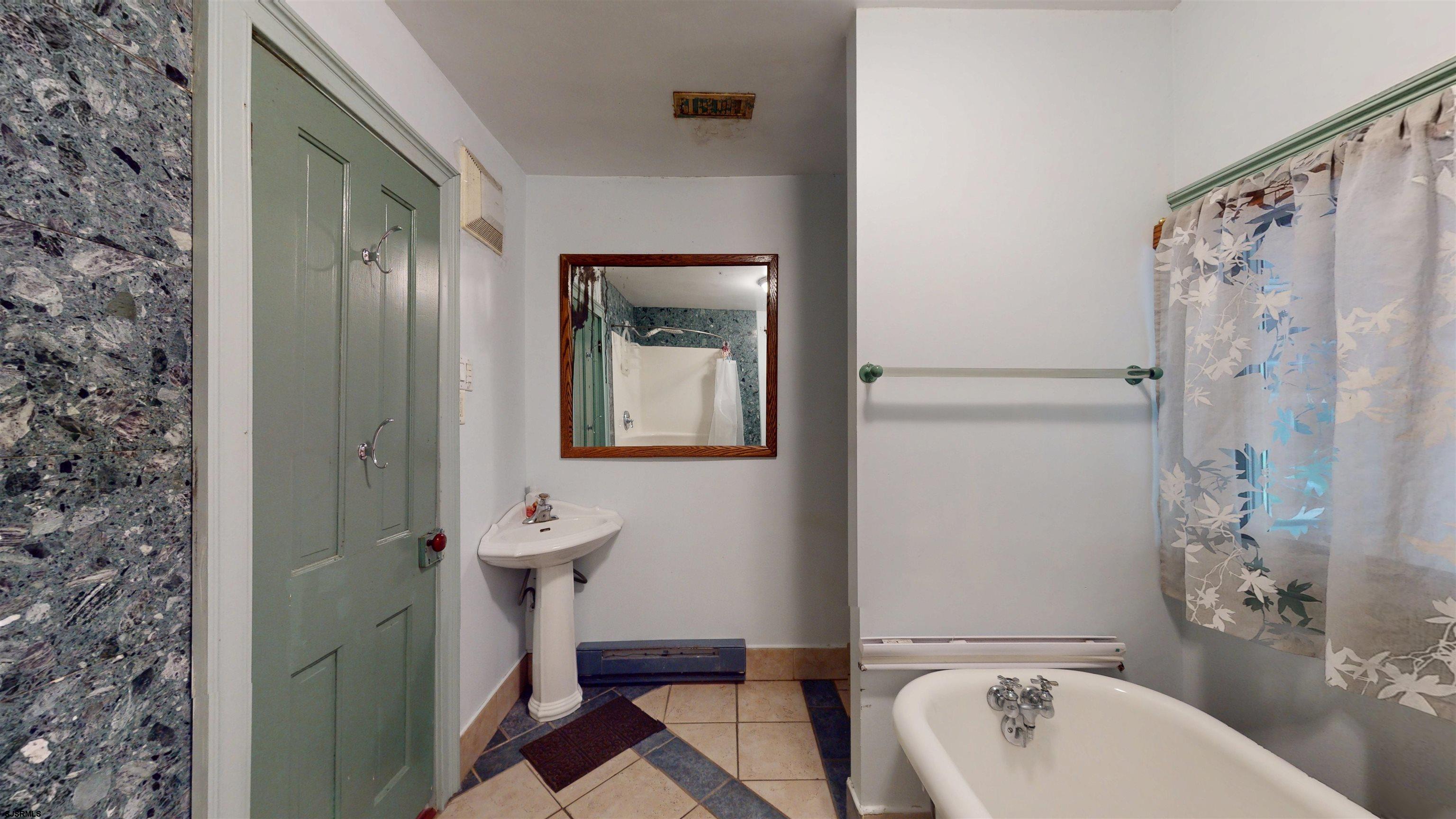 216 Old New York Road Port Republic, NJ 08241 - Photo 40 of 70 a bathroom with a bathtub shower sink mirror and toilet