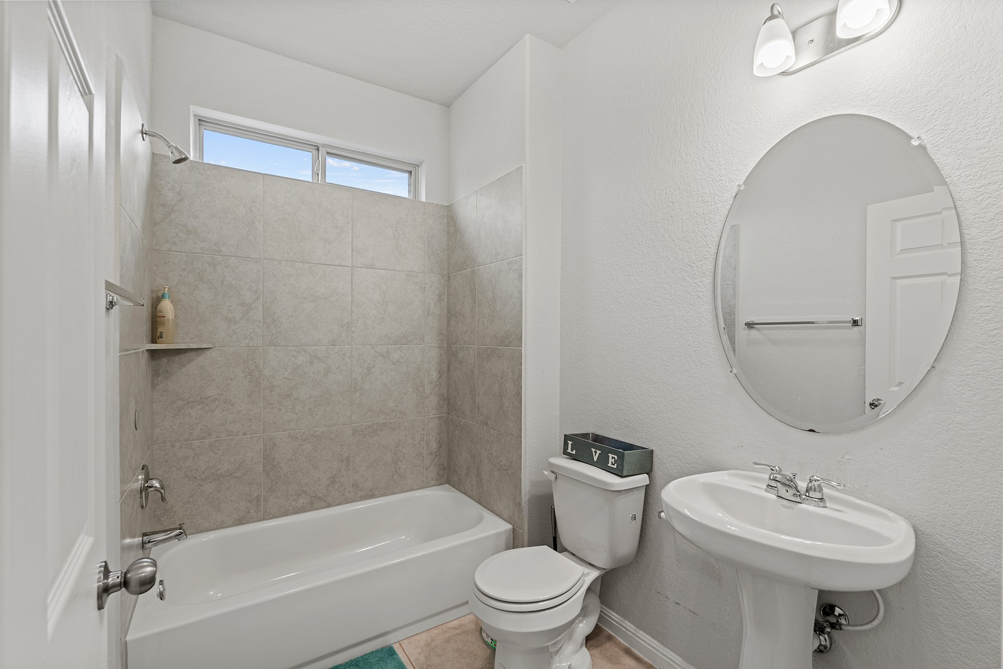 133 Caney Cove Leander, TX 78641 - Photo 13 of 30 Full bathroom featuring toilet, a sink, shower / tub combination, tile patterned flooring, and baseboards