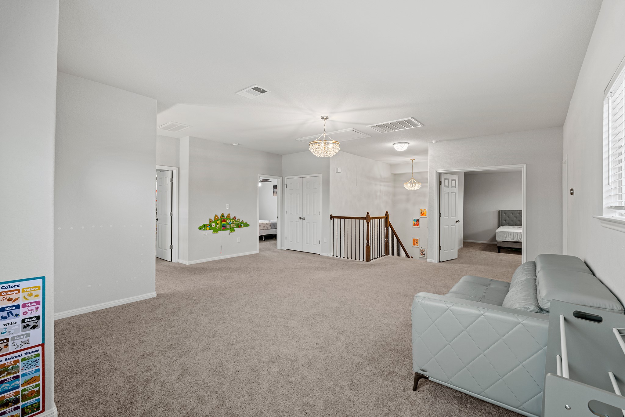 133 Caney Cove Leander, TX 78641 - Photo 16 of 30 Sitting room with carpet floors, a chandelier, visible vents, and an upstairs landing