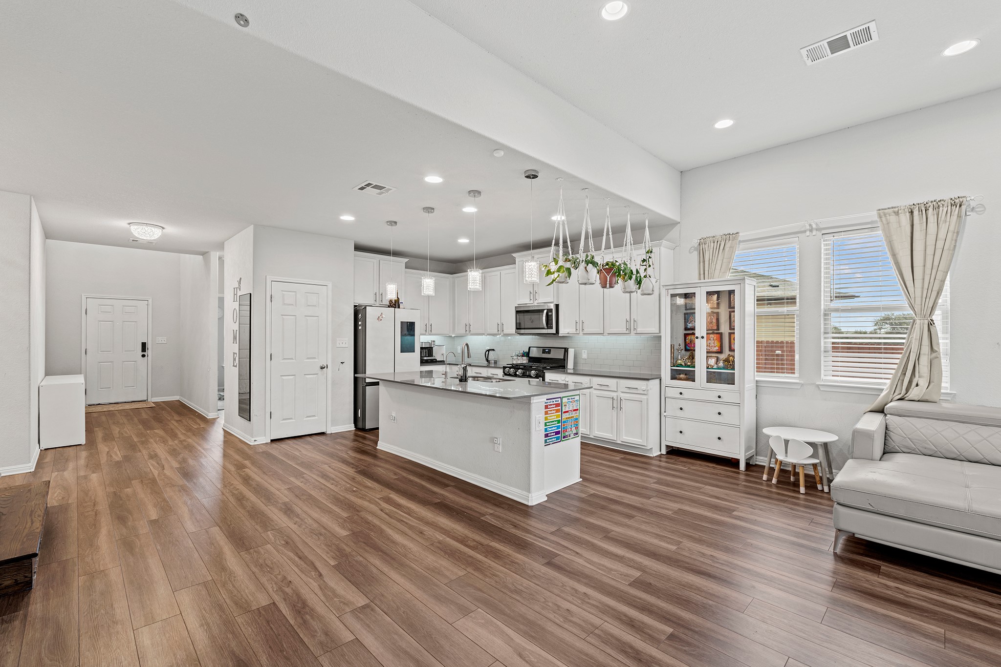 133 Caney Cove Leander, TX 78641 - Photo 30 of 30 Kitchen featuring dark wood-style floors, visible vents, stainless steel appliances, and open floor plan
