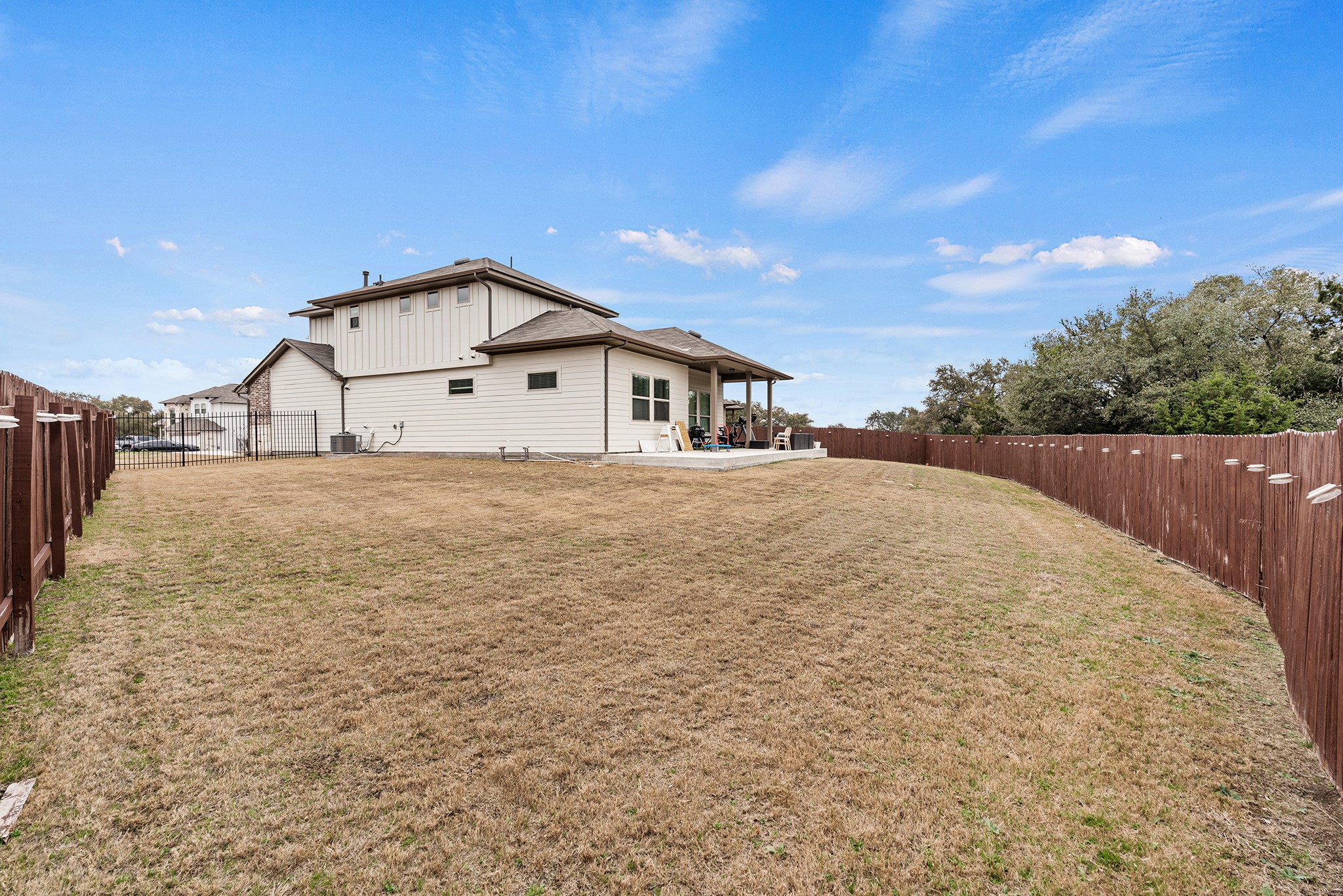 133 Caney Cove Leander, TX 78641 - Photo 28 of 30 Rear view of property with a patio area, a fenced backyard, central AC unit, and a yard