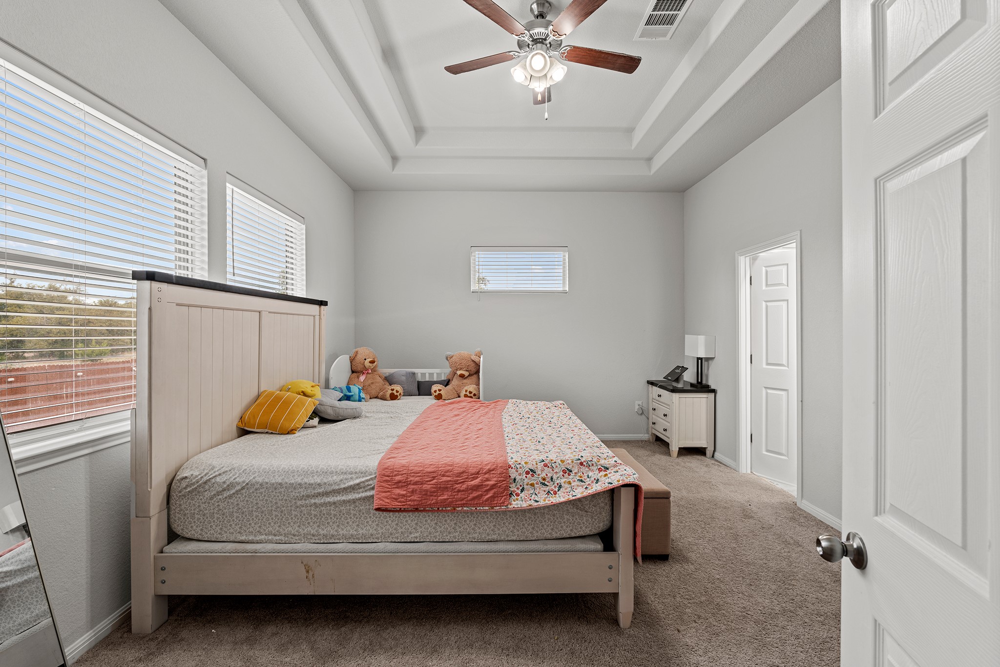 133 Caney Cove Leander, TX 78641 - Photo 6 of 30 Carpeted bedroom featuring a tray ceiling, a ceiling fan, visible vents, and baseboards