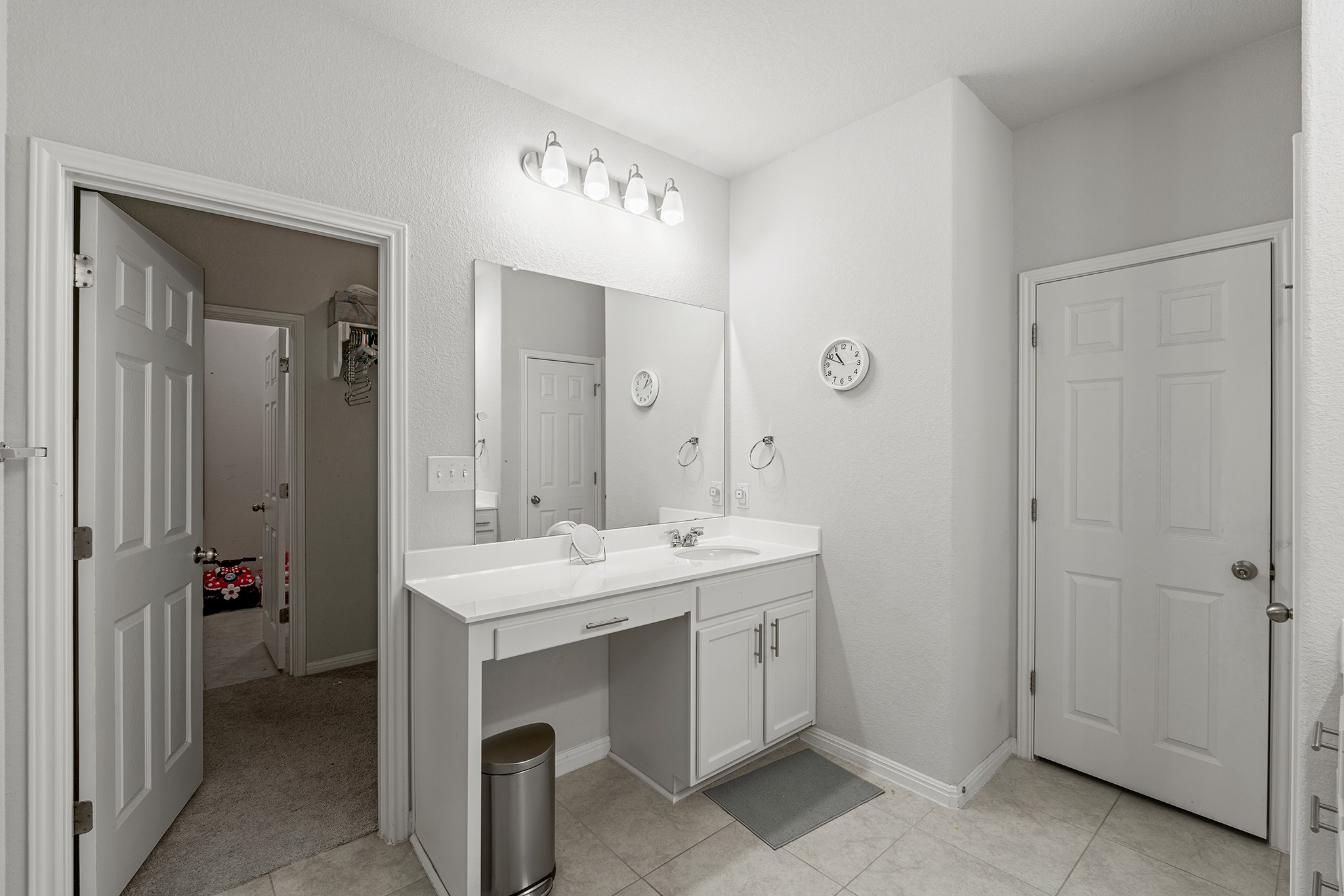 133 Caney Cove Leander, TX 78641 - Photo 7 of 30 Bathroom featuring baseboards, a walk in closet, vanity, and tile patterned floors